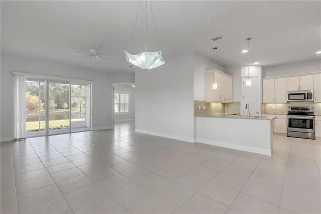 a large kitchen with cabinets and wooden floor