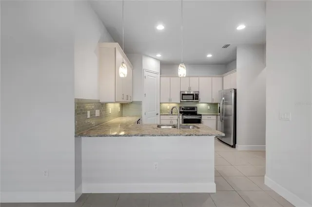 a kitchen with a sink and cabinets