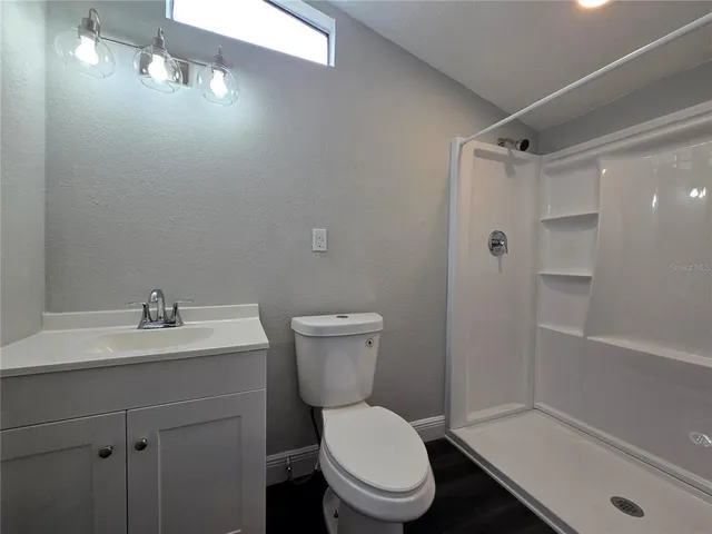 a white toilet sitting next to a bathroom sink