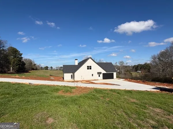 a view of a house with a yard and garage