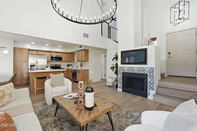 a living room with furniture a fireplace and a table