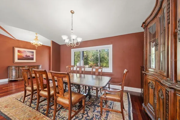 a living room with furniture and wooden floors