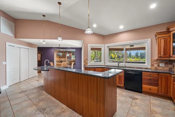 a view of a patio with table and chairs and potted plants