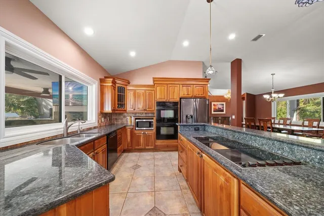 a bathroom with a granite countertop sink a mirror and shower