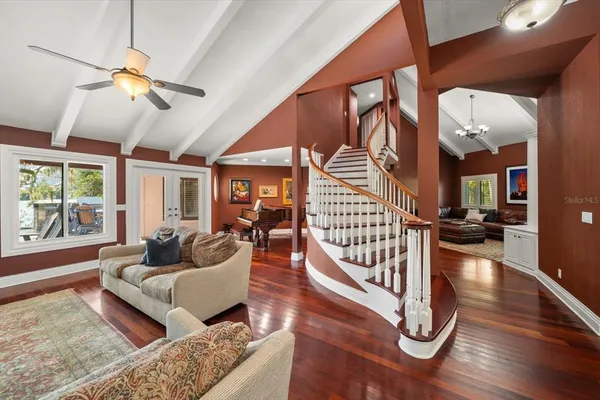 a view of a house with a big yard and large trees