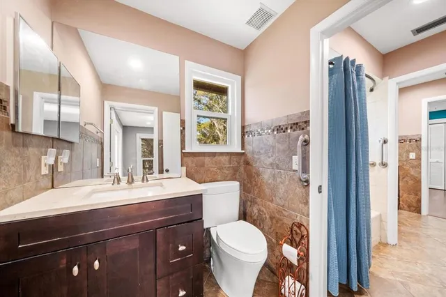 a view of a house with a tree in the background