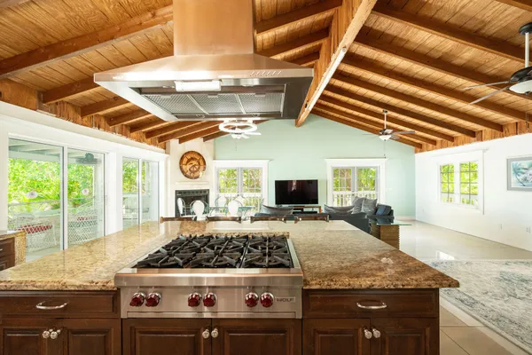 a kitchen with stainless steel appliances granite countertop a sink a stove and cabinets