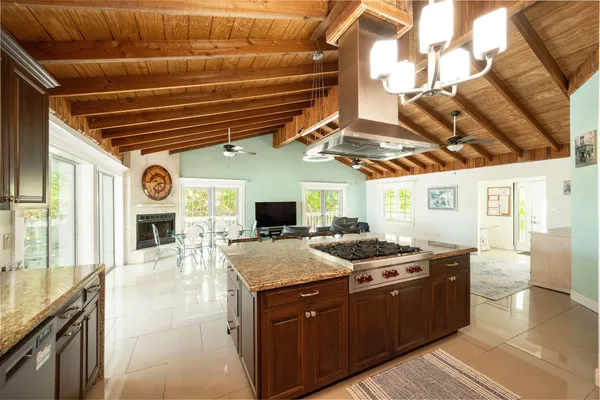 a kitchen with stainless steel appliances kitchen island granite countertop a stove and a sink