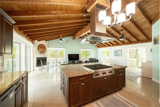 a kitchen with stainless steel appliances kitchen island granite countertop a stove and a sink
