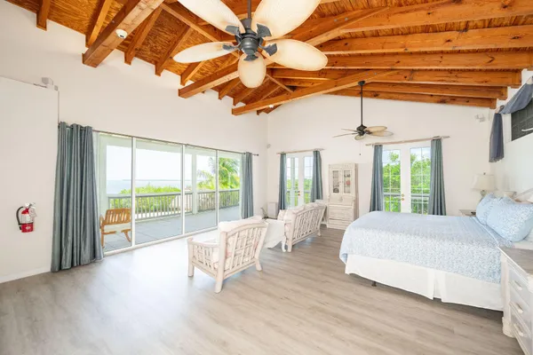 a bedroom with a bed and a large window with outer view