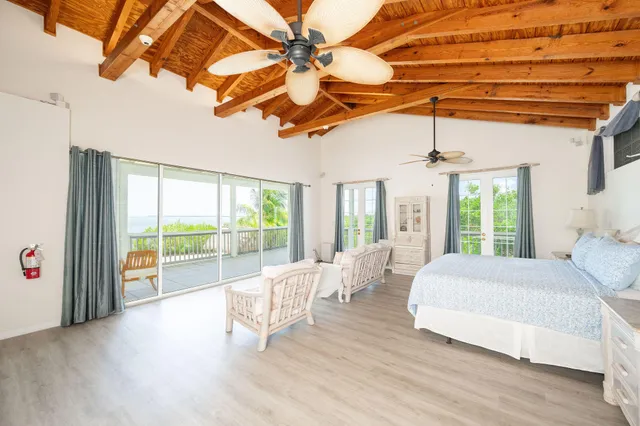 a bedroom with a bed and a large window with outer view