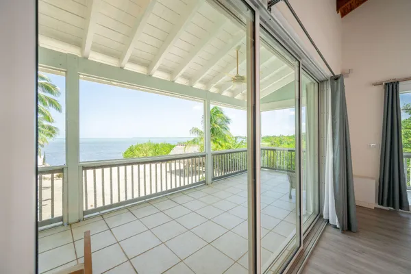 a bedroom with a bed couch and a window