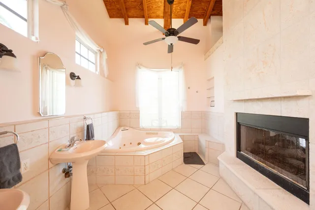 a bedroom with a large bed and wooden floor