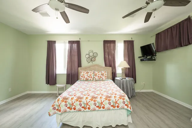a view of a house with pool and sitting area