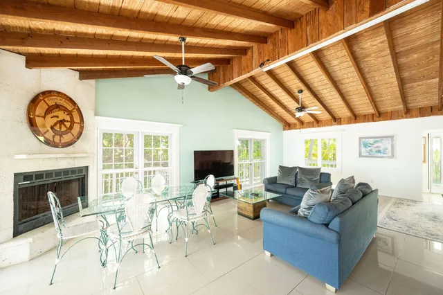 a kitchen with stainless steel appliances granite countertop a stove a sink dishwasher a dining table and chairs with wooden floor