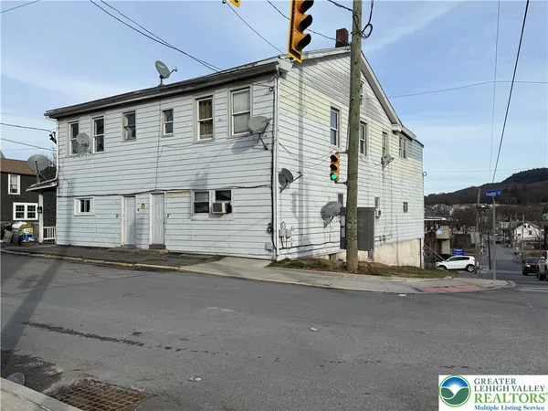 a front view of a house with a road