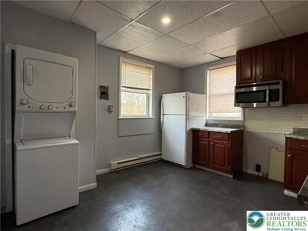 a kitchen with granite countertop wooden cabinets a sink and dishwasher