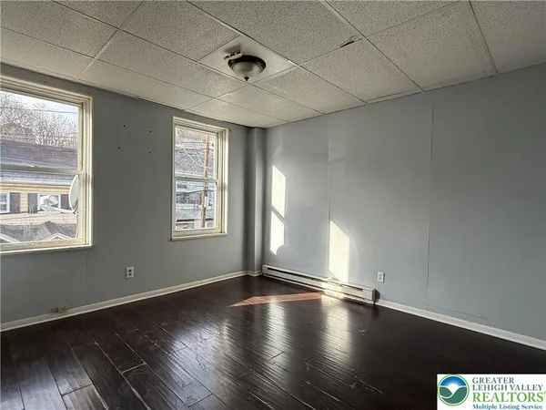 a view of an empty room and wooden floor