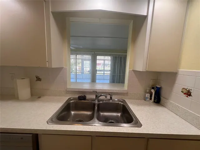 a kitchen with a sink and cabinets