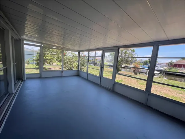 an empty room with large windows