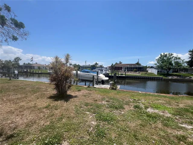 a view of a lake with houses in the back