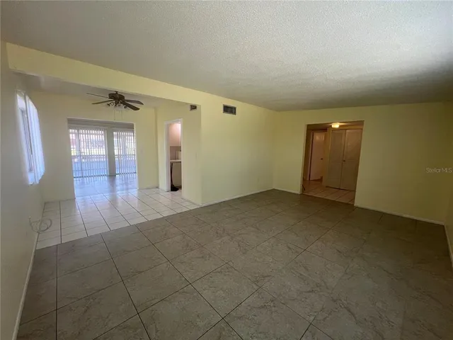 a view of a hallway with wooden floor and cabinet