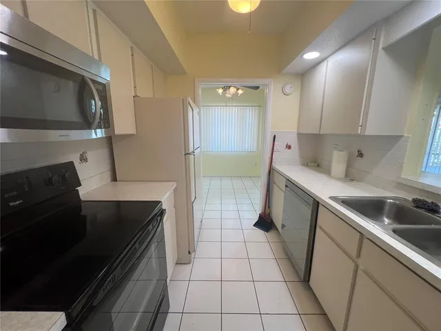 a kitchen with a sink stainless steel appliances and cabinets