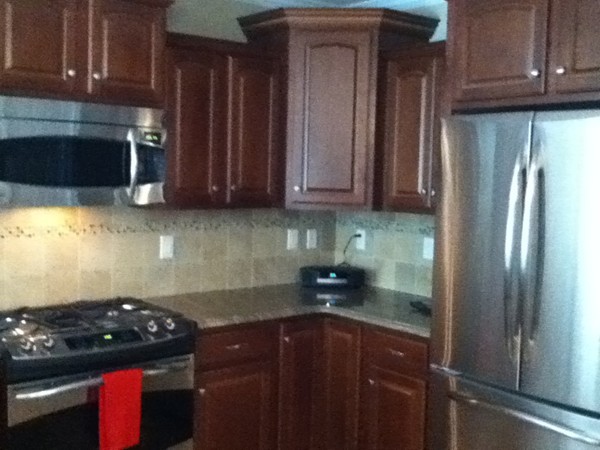 98 Dudley Road, Unit 98 Berlin, MA 01503 - Photo 5 of 14 a kitchen with stainless steel appliances granite countertop a refrigerator and a stove top oven