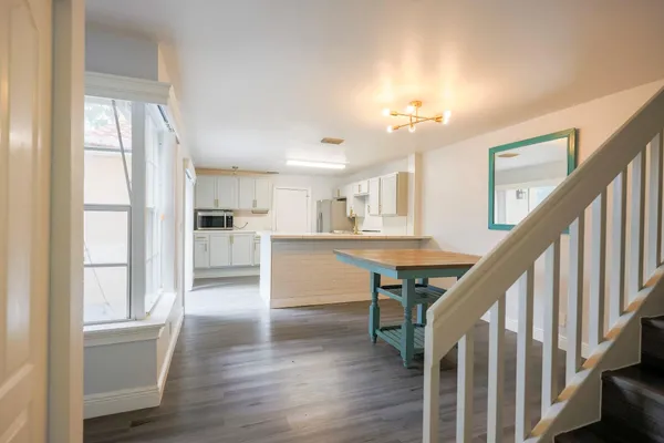 a view of a room with wooden floor and windows