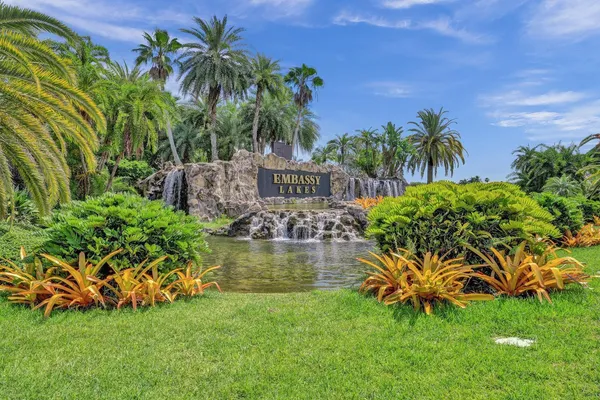 a view of a garden with flowers and wooden fence