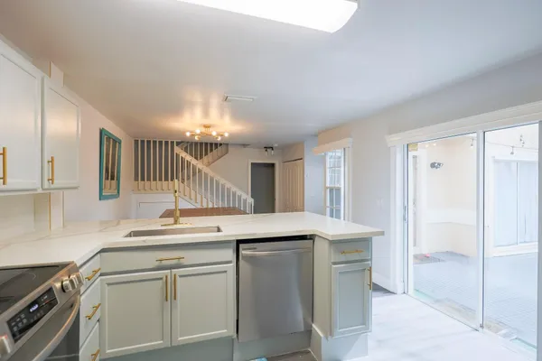 a kitchen with a sink and a refrigerator
