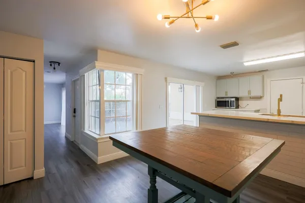 a view of livingroom with table and staircase
