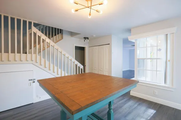 a room with furniture wooden floor and a chandelier