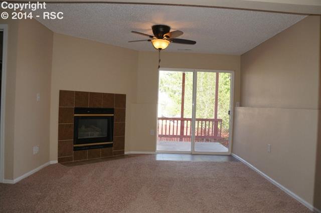 616 Rye Ridge Road Fountain, CO 80817 - Photo 12 of 20 Family room has a gas fireplace and walks out to the patio