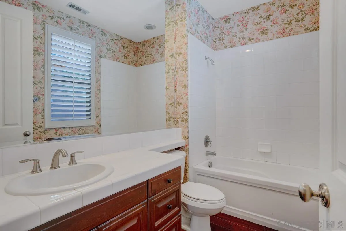 961 Red Granite Road Chula Vista, CA 91913 - Photo 10 of 27 a bathroom with a granite countertop sink toilet and shower