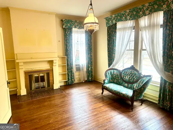 a living room with furniture window and wooden floor