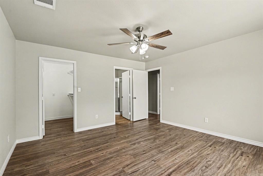 6113 Haley Lane Fort Worth, TX 76132 - Photo 19 of 38 Primary bedroom includes new luxury vinyl plank flooring, new ceiling fan. Ensuite bathroom and walk-in closet.