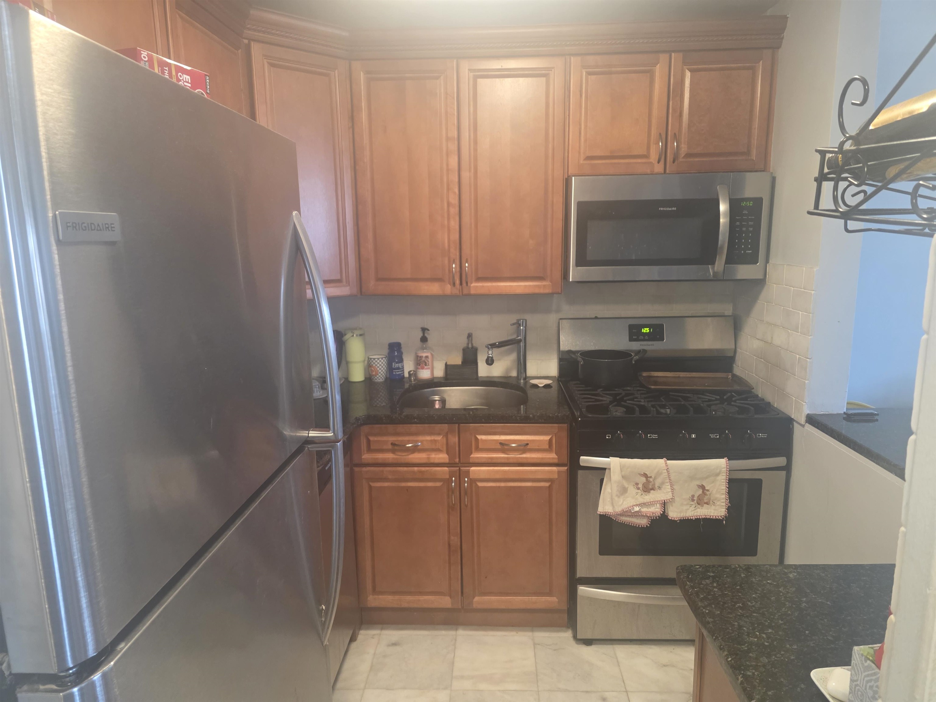 7100 Boulevard East, Unit 9R Guttenberg, NJ 07093 - Photo 11 of 19 a kitchen with stainless steel appliances granite countertop a refrigerator and a stove top oven