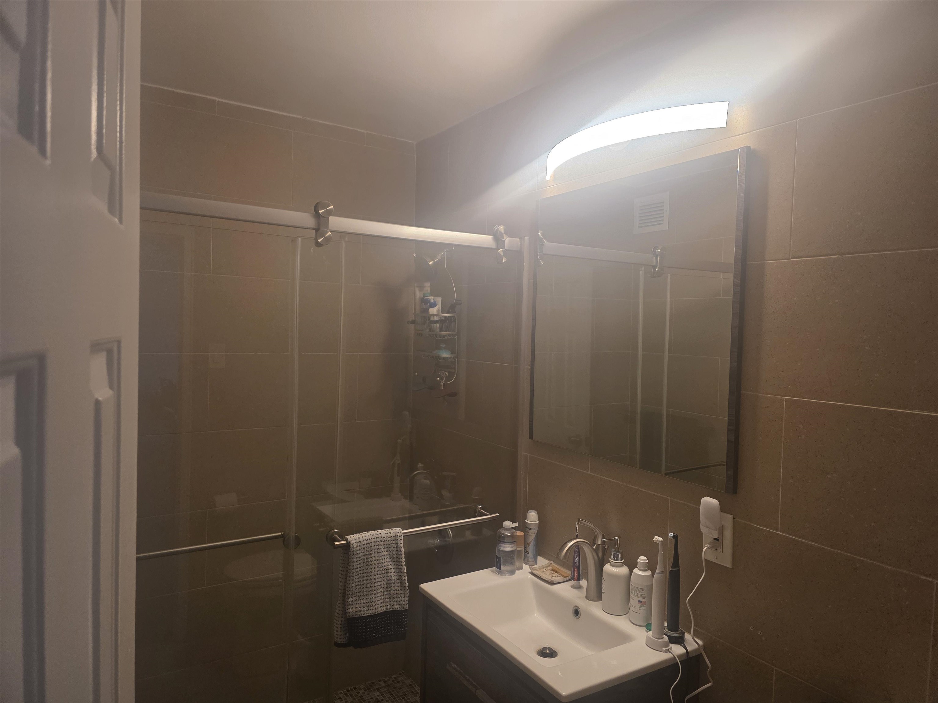 7100 Boulevard East, Unit 9R Guttenberg, NJ 07093 - Photo 12 of 19 a bathroom with a shower a sink and mirror