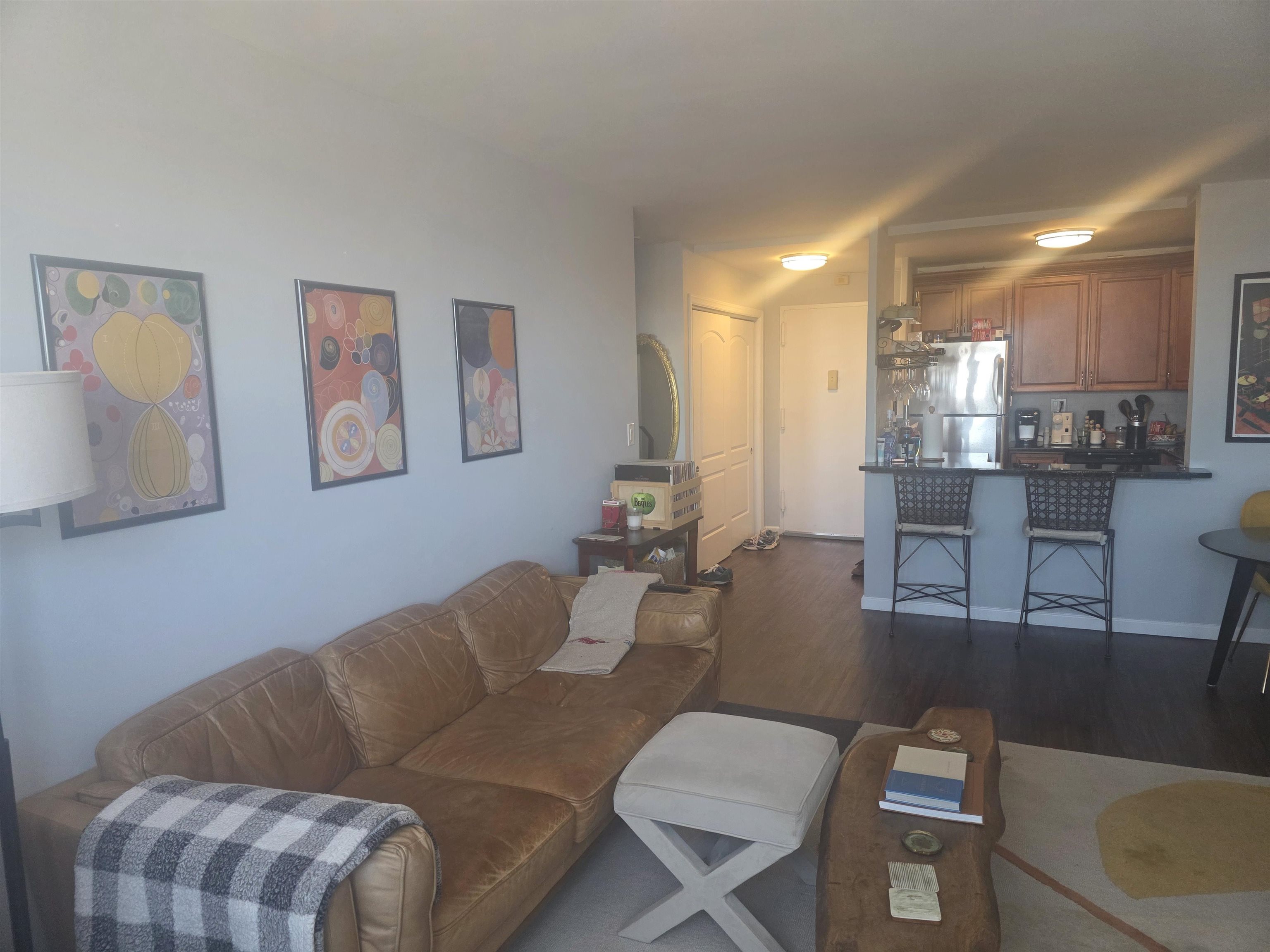 7100 Boulevard East, Unit 9R Guttenberg, NJ 07093 - Photo 9 of 19 a living room with furniture and a dining table with kitchen view