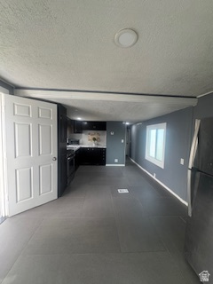 8155 South Redwood Road, Unit 96 West Jordan, UT 84088 - Photo 7 of 17 Unfurnished living room featuring a textured ceiling