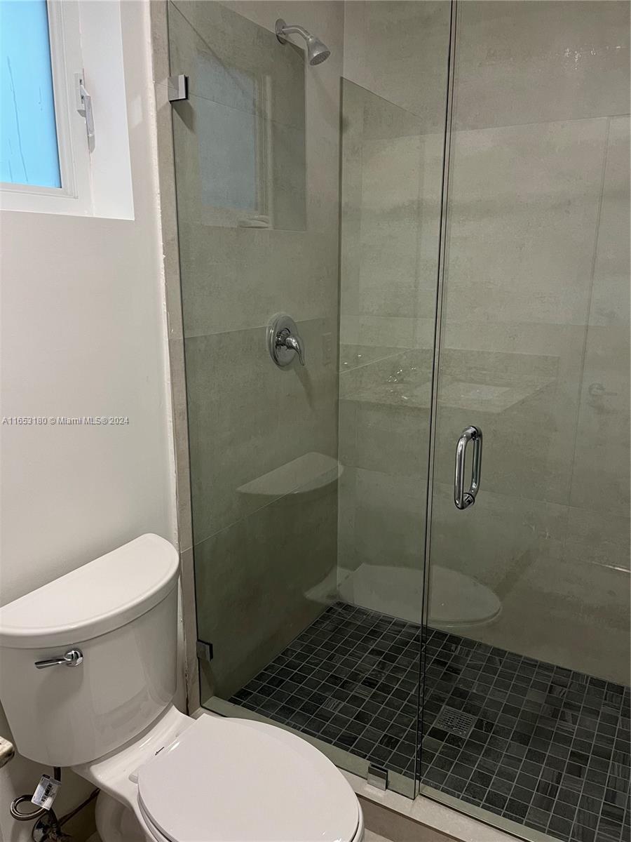 535 Southwest 5th Street, Unit 5 Miami, FL 33130 - Photo 11 of 19 a bathroom with a toilet and a shower