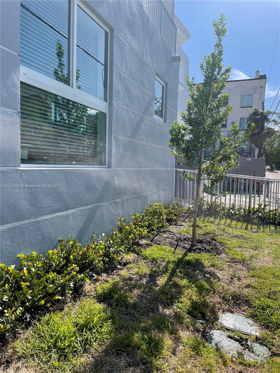535 Southwest 5th Street, Unit 5 Miami, FL 33130 - Photo 16 of 19 a view of a house with a yard