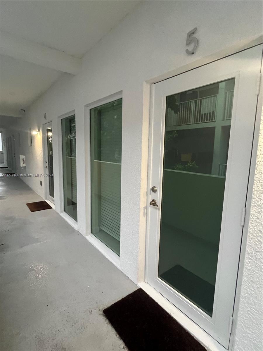 535 Southwest 5th Street, Unit 5 Miami, FL 33130 - Photo 3 of 19 a view of a bathroom with a glass door and a shower