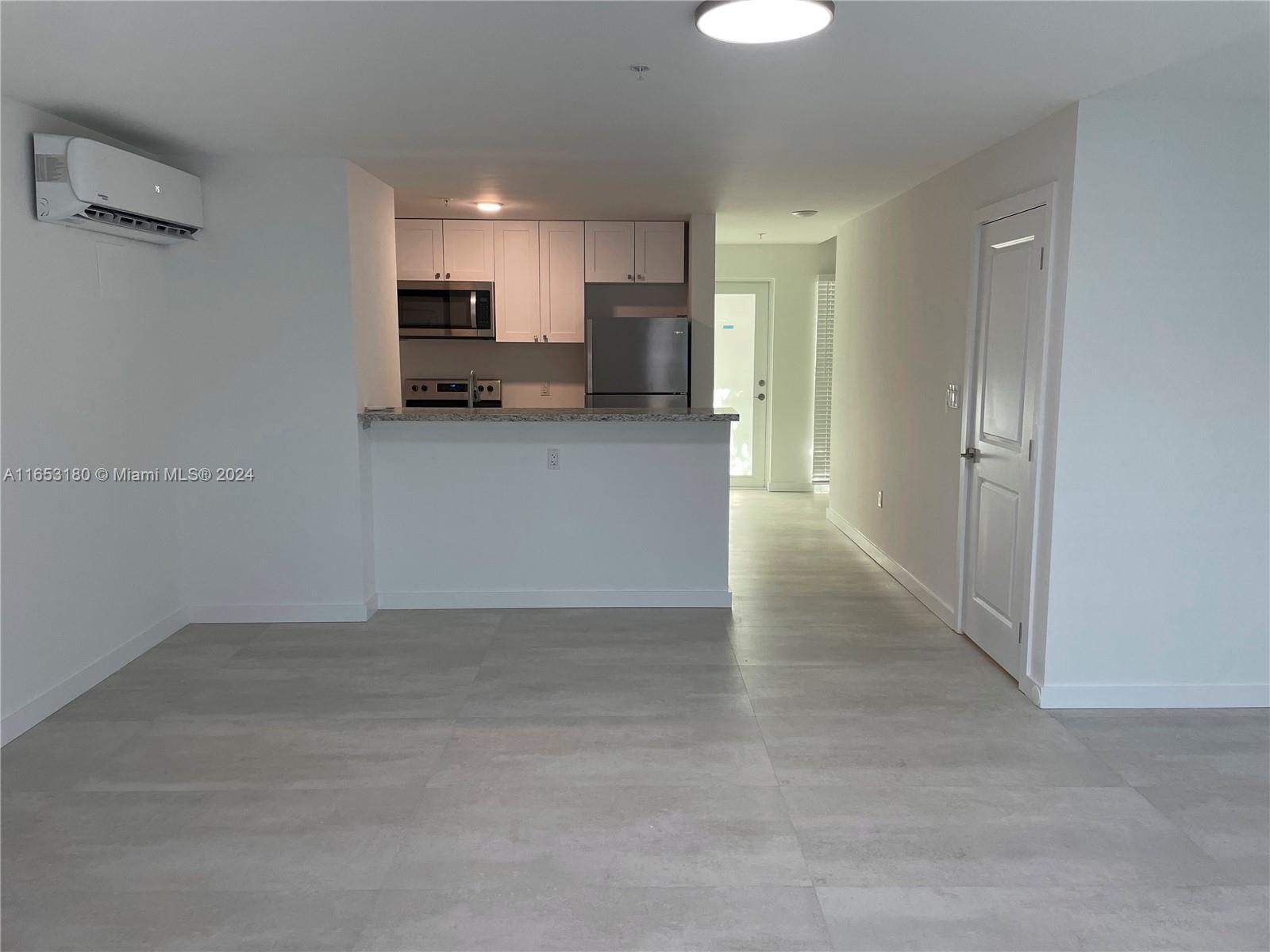 535 Southwest 5th Street, Unit 5 Miami, FL 33130 - Photo 10 of 19 a view of kitchen with refrigerator and window