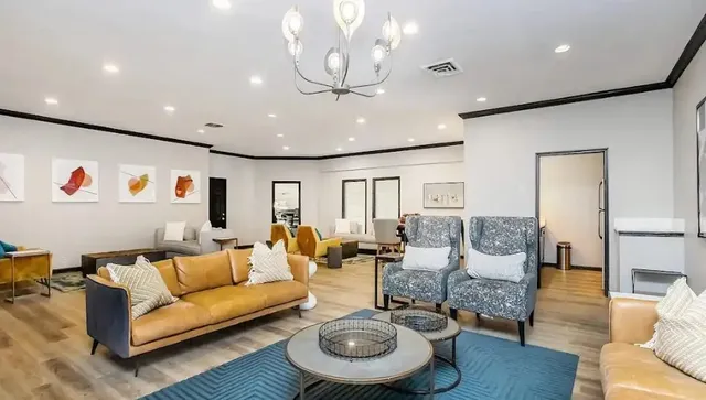 a kitchen with a sink dishwasher and white cabinets with wooden floor