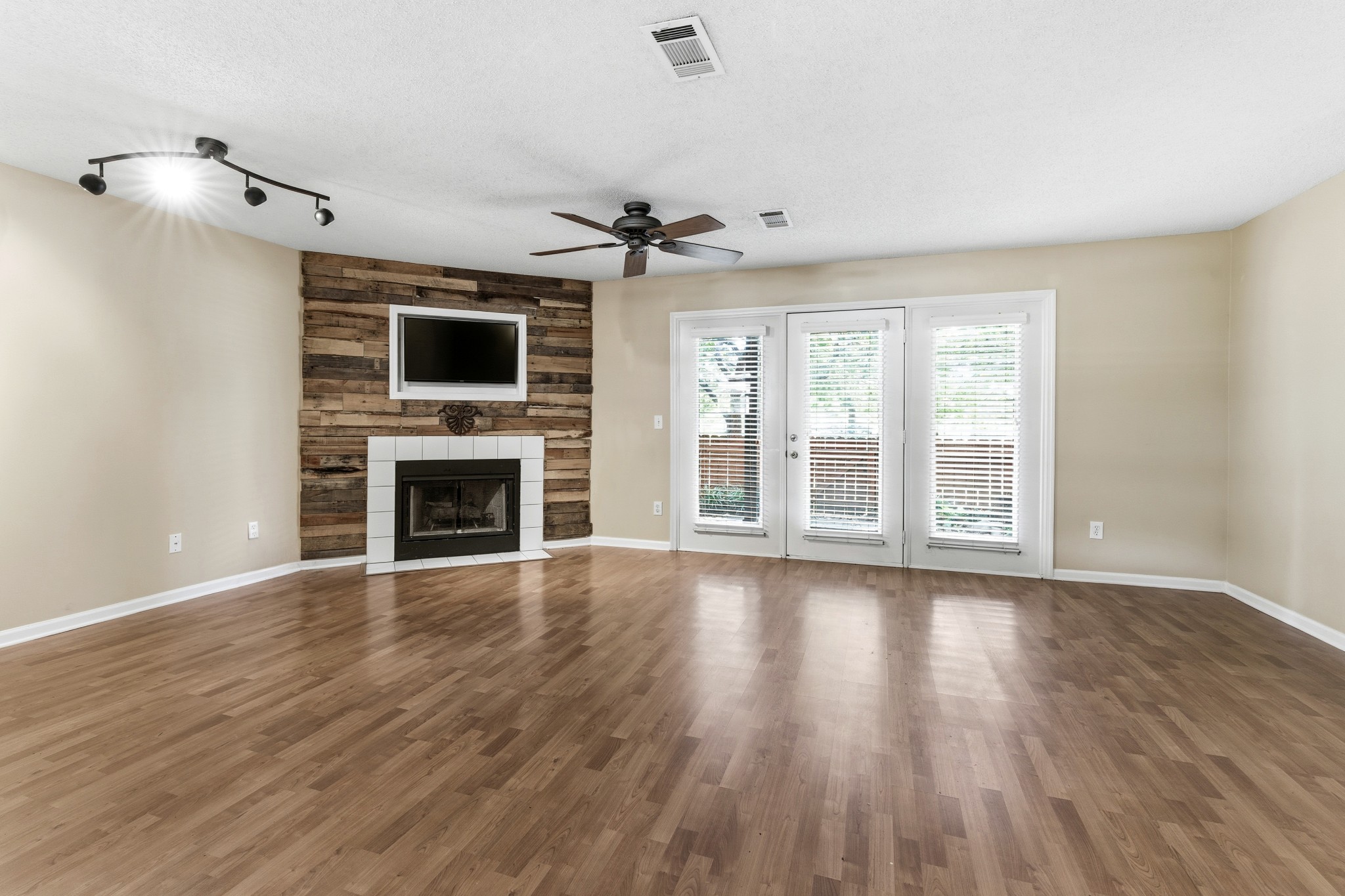 2009 Emery Lane Franklin, TN 37064 - Photo 9 of 39 a view of an empty room with wooden floor and a fireplace
