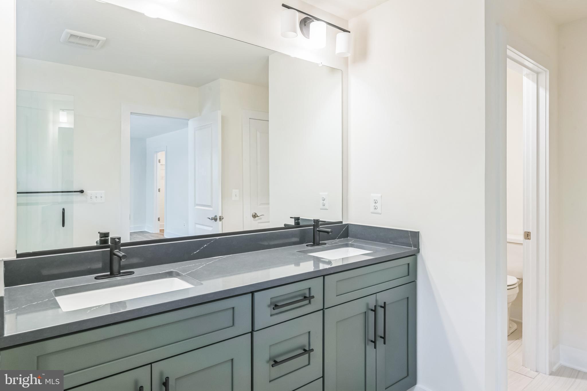 383 Scranton Lane Ocean View, DE 19970 - Photo 12 of 15 a bathroom with a granite countertop sink and a mirror