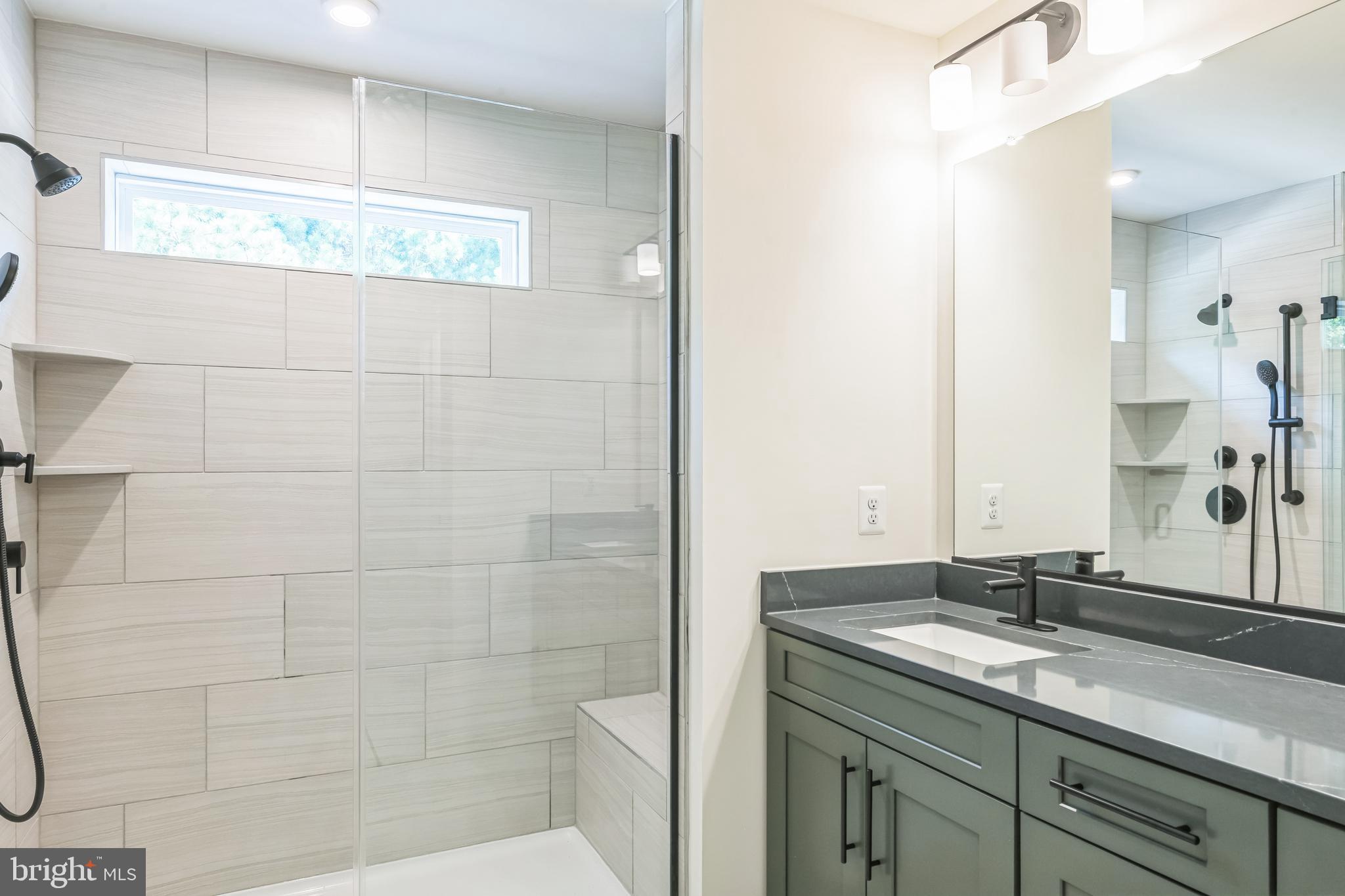 383 Scranton Lane Ocean View, DE 19970 - Photo 13 of 15 a bathroom with a granite countertop sink a mirror and a shower