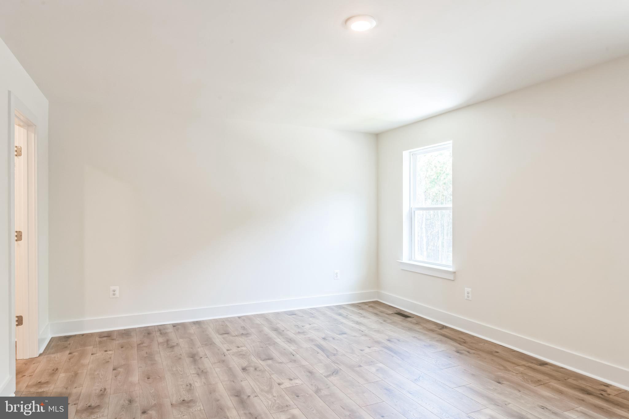 383 Scranton Lane Ocean View, DE 19970 - Photo 14 of 15 an empty room with wooden floor and windows
